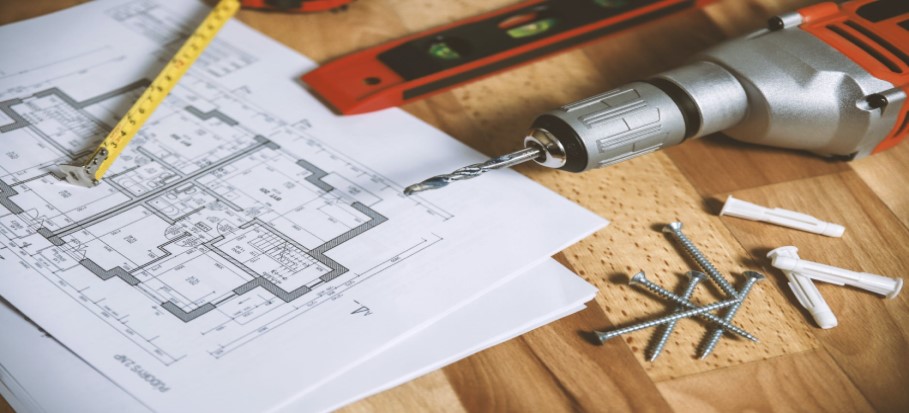 construction plans and a drill